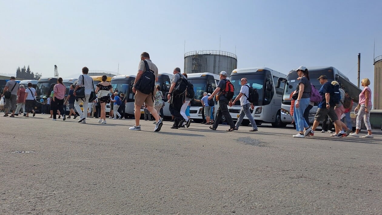 Travelers boarding buses organized by travel agencies in Vietnam